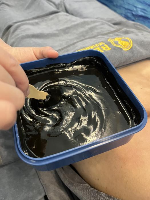 The herbal mud is warmed and scooped out