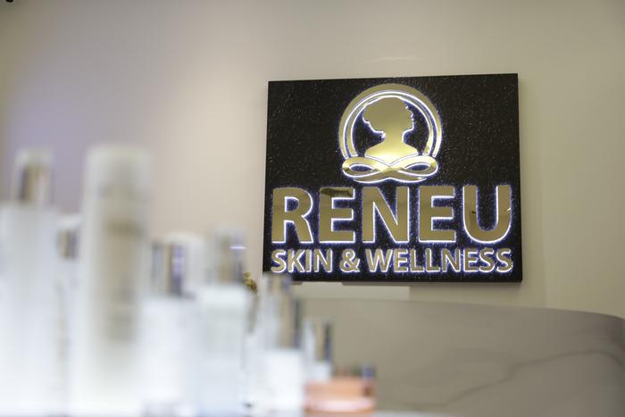 RENEU logo wall behind the skincare display